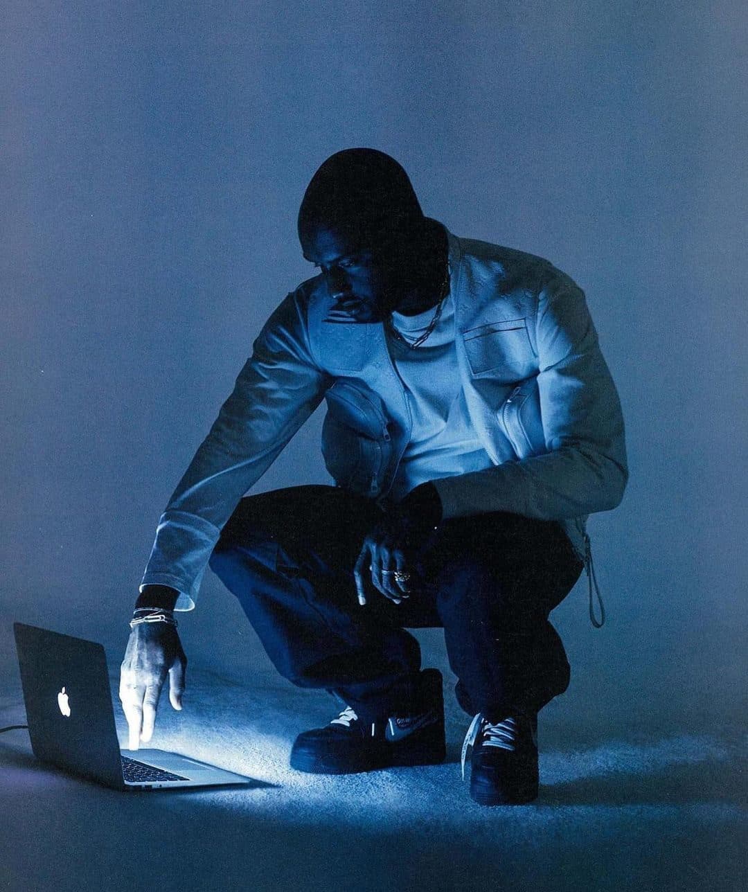 Writer lit by screen light in a dark room