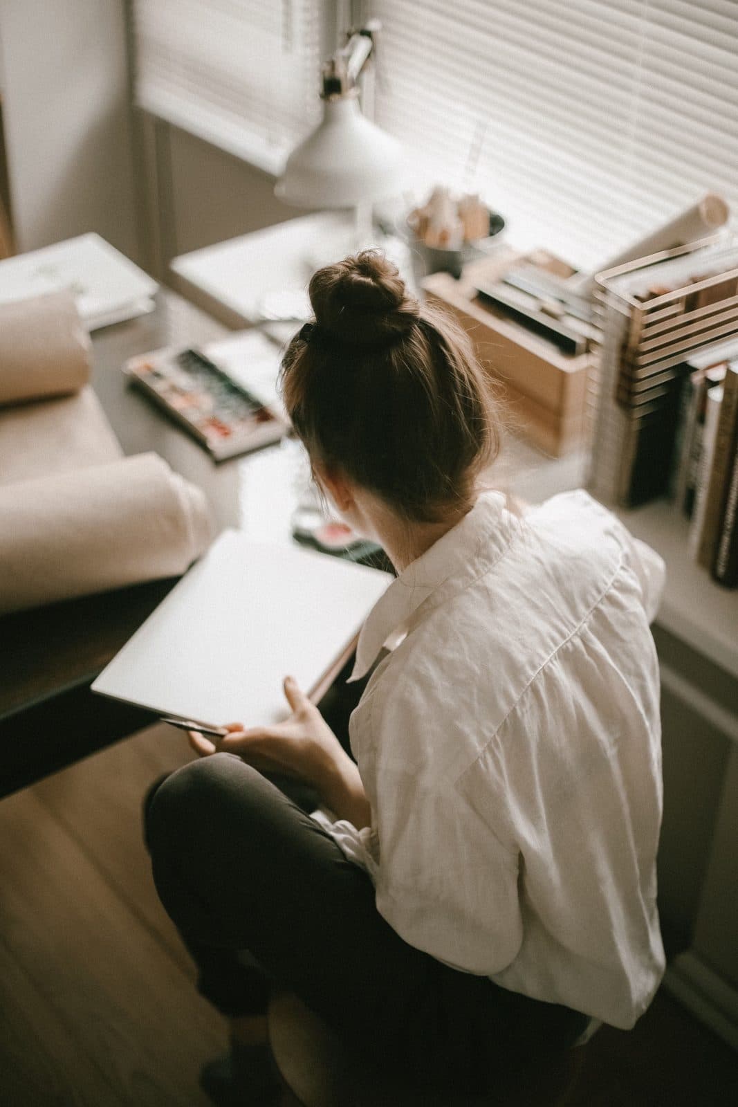 Overhead view of a writer at a desk mid-draft